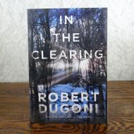 In the Clearing by Robert Dugoni paperback book: Front