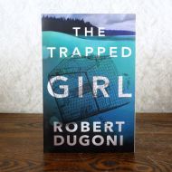 The Trapped Girl by Robert Dugoni Paperback Book: Front