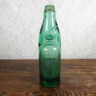 Codd Neck green glass self sealing soda bottle. Original rubber ring, marble. Raised foreign language: Front