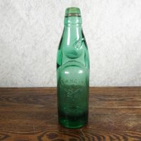 Codd Neck green glass self sealing soda bottle. Original rubber ring, marble. Raised foreign language: Front - Click to enlarge