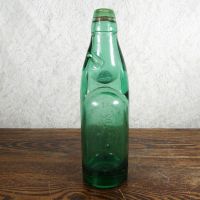 Codd Neck green glass self sealing soda bottle. Original rubber ring, marble. Raised foreign language: Back - Click to enlarge