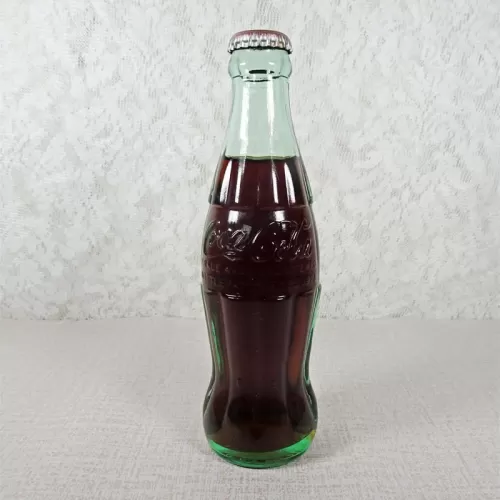 Ottumwa Iowa vintage 8 oz full hobbleskirt no refill Coke bottle with Coca Cola Classic cap: Front