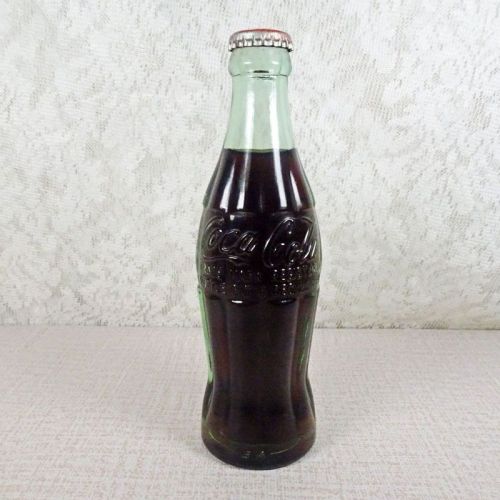 Scottsbluff Nebraska vintage 6 oz full hobbleskirt Coke bottle with red Coca Cola Classic cap: Front