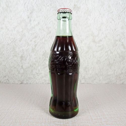 Deming New Mexico vintage 6 oz full hobbleskirt Coke bottle with red Coca Cola Classic cap: Front