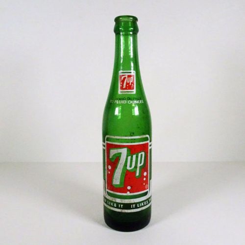 Vintage Seven Up soda bottle with the seven bubble logo. Green glass with red and white ACL graphics: Front