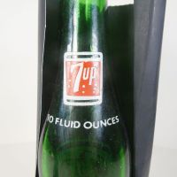 Vintage Seven Up soda bottle with the seven bubble logo. Green glass with red and white ACL graphics: Top Logo - Click to enlarge