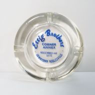 Essig Brothers corner annex vintage round clear glass ashtray with blue wording: Top