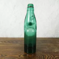 Vintage Codd Neck Victory V soda bottle with rubber ring and marble in heavy thick green glass: Front
