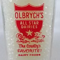 Olbrych's Dairy vintage clear glass acl one quart milk bottle with red graphics and textured body: Closeup - Click to enlarge