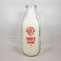 Thiele Dairy vintage clear glass acl one quart milk bottle with red graphics: Front - Click to enlarge