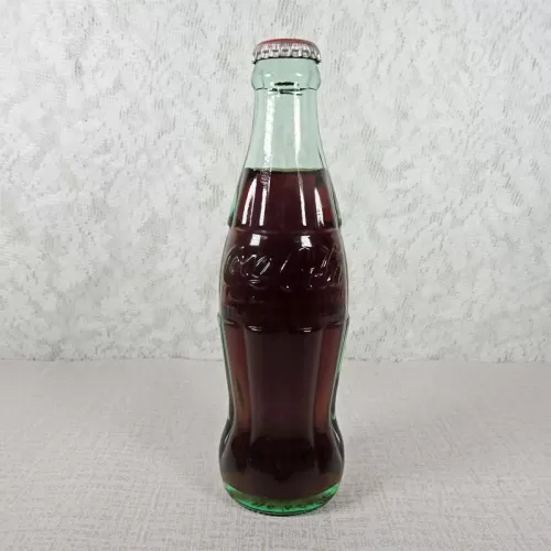 Akron Ohio vintage 8 oz full hobbleskirt no refill Coke bottle. Coca Cola Classic cap. Aqua glass: Front