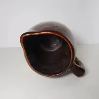 Antique glazed stoneware pitcher with handle. Brown top, beige bottom, band of a third color separating them: Inside - Click to enlarge